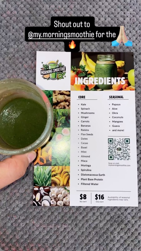 A hand holds a green smoothie next to a printed ingredient list and menu for "Morning Smoothie Co." on a textured gray surface.